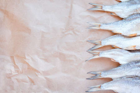 Dried fishes template banner on craft paper background with empty space for text. Flat Salted roach web cover backdrop. Seafood snack poster, flyer decorative design. Fish frame for promotion shop.の写真素材