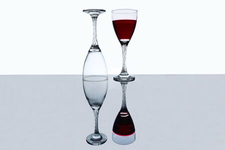 wine glass on a glass tableの写真素材