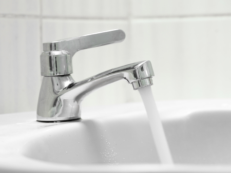 The faucet was left in the toothbrush. Losing a lot of water is unnecessary. Let's save waterの写真素材