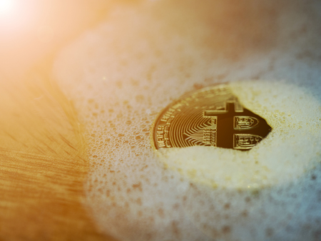 Golden bitcoin in a soap bubble. Concept of distributed ledger technology and bitcoin bubble and digital electronic binary money financial.の写真素材