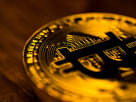 Golden bitcoin cryptocurrency banking money transfer business technology on wooden table. Concept of distributed ledger technology and digital electronic binary money financial.の写真素材