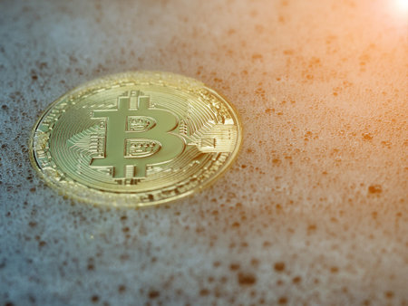 Golden bitcoin coin in a soap bubble. Concept of distributed ledger technology and bitcoin bubble and digital electronic binary money financial.の写真素材