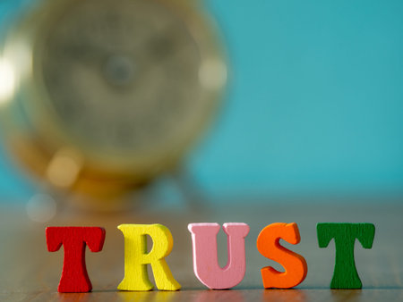 Trust. English alphabet made of wooden letter color. Alphabet trust on wooden table and vintage...