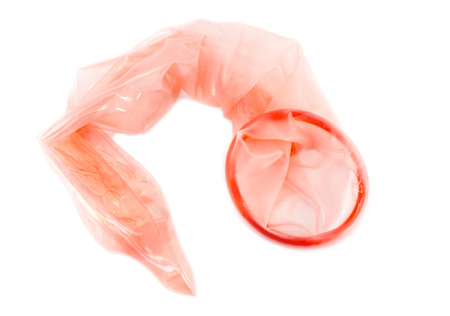 Used red condom isolated on white background, Having safe sex for Valentine's Day, Protected yourself from Aids with love, Stop AIDS concept.の写真素材