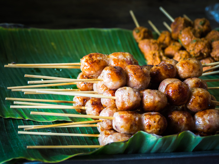 Thai sausage and grilled on banana leaf ready for sale in Thailand street food.の写真素材