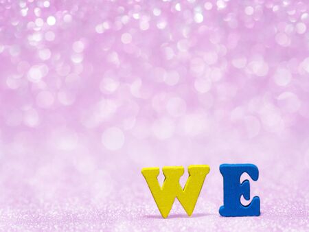 WE text on pink abstract glitter background with bokeh. lights blurry soft pink for the romance background and background copy space for text. Valentines day, love concept and love backgroundの写真素材
