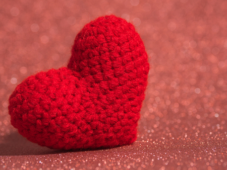 Red yarn heart on the red floor and background copy space for text. Valentines day, love concept and love backgroundの写真素材