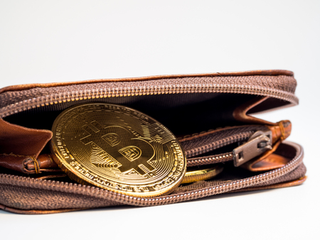 Close up bitcoin gold coins with wallet on the white background. Virtual cryptocurrency concept.の写真素材