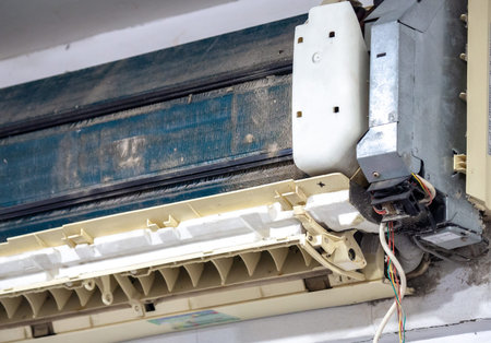 Older air conditioner in the wash. After not maintaining it for a long time. Dusty interior And the parts are rusty. Accumulating respiratory infections.の写真素材