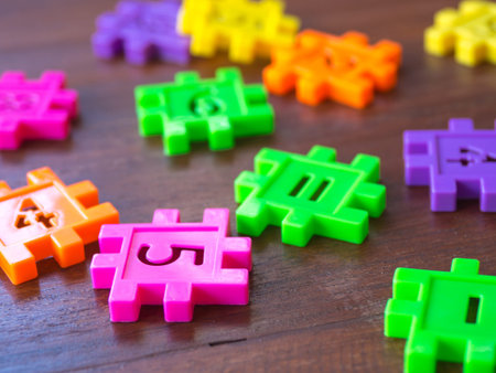 colorful puzzle Jigsaw plastic number on the wooden table. Concept of education and math learning