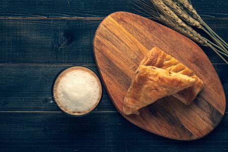 Coffee white cup and croissant for breakfast on wooden background on the table. Perfect breacfast in the morning.の写真素材