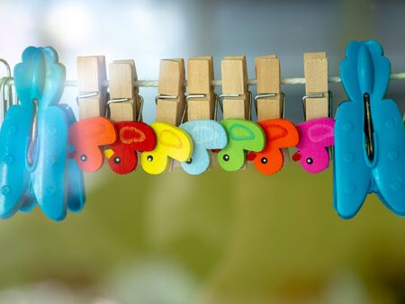 colorful of wooden Paper clip attached to the railの写真素材