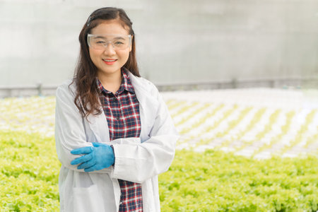 Agricultural Engineer standing and smiling in hydroponic Greenhouse farm after test plant system and...