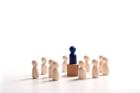 Wooden figure standing on the box for show influence and empowerment. Concept of business leadership for leader team, successful competition winner and Leader with influenceの写真素材