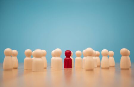 Wooden figure standing with team to show influence and empowerment. Concept of business leadership for leader team, successful competition winner and Leader with influenceの写真素材