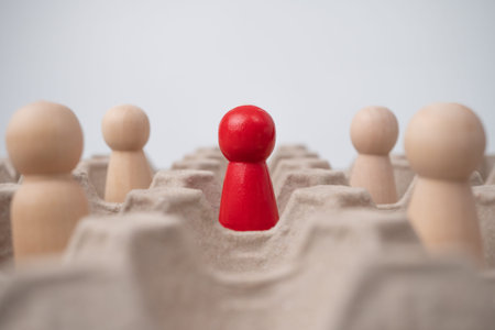 A wooden figure standing with team to influence and empowerment. Concept of leadership, successful...