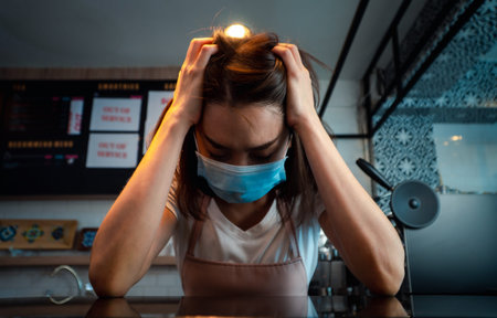 Asian woman coffee shop business owner Stressed and disappointed from The effects of the coronavirus...