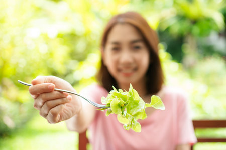 The happy beautiful Asian healthy middle aged woman sitting in the balcony of the house beside the...