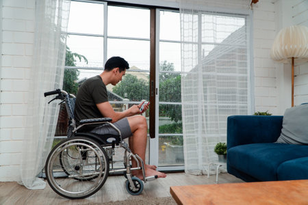 A disabled man sitting in a wheelchair is disappointed and Desperate to heal after car accident. Concept of Careless Driving, Insurance and Mental health care After the accidentの写真素材