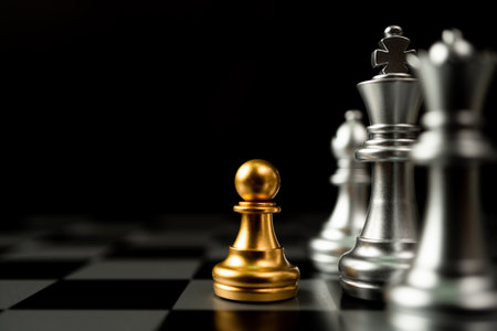 Golden Chess pawn standing in front of other chess, Concept of a leader must have courage and challenge in the competition, leadership and business vision for a win in business gamesの写真素材