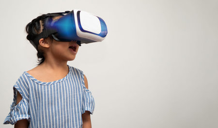 Little Asian girl child with virtual reality headset is exciting for new experiencing. Concept of 3D...