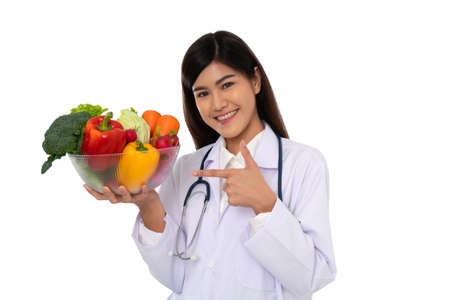 Doctor or nutritionist holding fresh fruit (Orange, red and green apples) and smile in clinic. Healthy diet Concept of nutrition food as a prescription for good health, fruit is medicineの写真素材