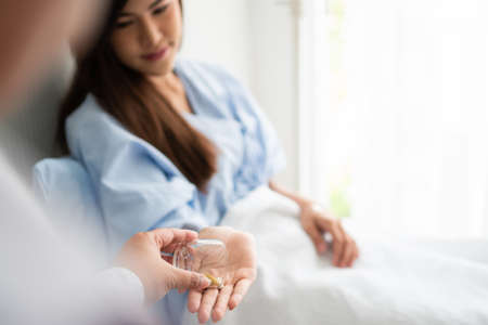 Doctors give medicine to patients in hospitals. Concept of healthcare and medicalの写真素材