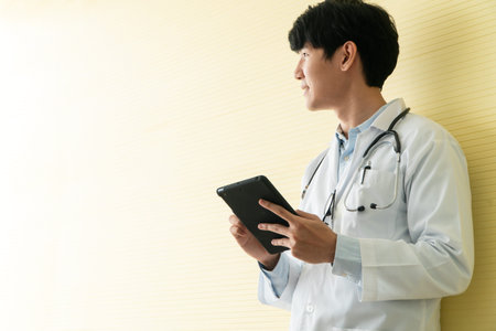 Young Asian doctors using tablets to check data and information for the health examination of patients. Concept of digital, technology and communication for medical.の写真素材