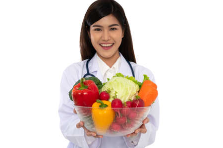Doctor or nutritionist holding fresh fruit (Orange, red and green apples) and smile in clinic. Healthy diet Concept of nutrition food as a prescription for good health, fruit is medicineの写真素材