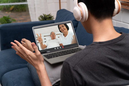 Asian man video conference meeting with sick elderly father to encourage and inquire about illness....