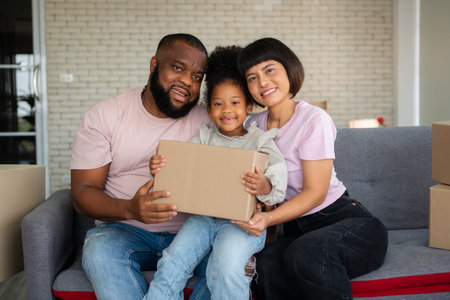 Mixed Race families are sitting on the sofa for rest after moving to a new house on the first day...