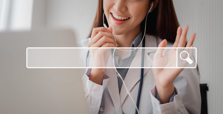 Asian woman doctor is online visiting with a patient on the internet application and Listening of...