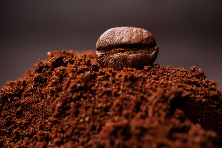 Closeup of coffee beans at the mixed heap of roasted coffee with copy space for text. Concept of...