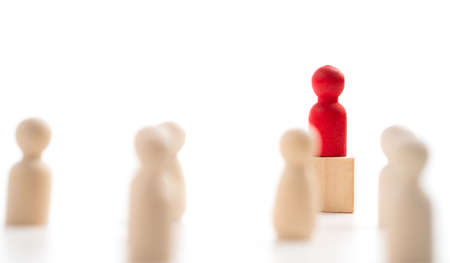 The red wooden figure standing on the box show influence and empowerment. Concept of business leadership for leader team, successful competition winner and Leader with influenceの写真素材