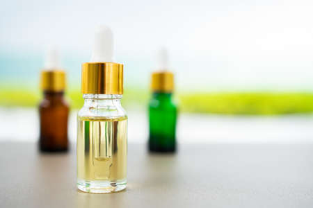 Set of multi color glass bottles with dropper on the table. Concept of aroma oil, cosmetic and beauty skin.の写真素材