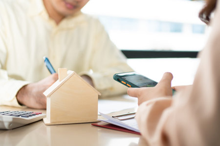 Client signs home loan document to buy homes with real estate property agent or lawyer. Real estate...