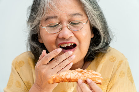 Happy Asian senior women enjoying eating pieの写真素材