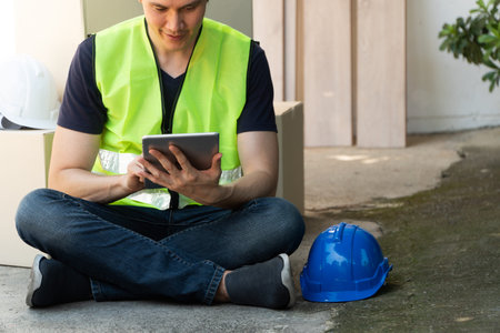 Asian homeowner holding tablet and try to understand a plan for house renovation and design for home...