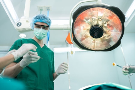 Low Angle Shot of Professional surgeons team performing surgery in operating room, surgeon, Assistants, and Nurses Performing Surgery on a Patient, health care cancer and disease treatment conceptの写真素材