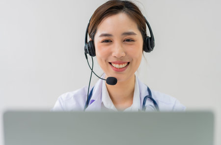 Asian therapist woman doctor is online visiting with a patient on the internet application. Her...
