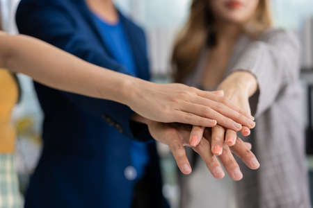 Group of Asia young entrepreneurs creative people join hand and excited for success project, working together in the office. Stratup business team discusses and shares ideas for new projects.の写真素材