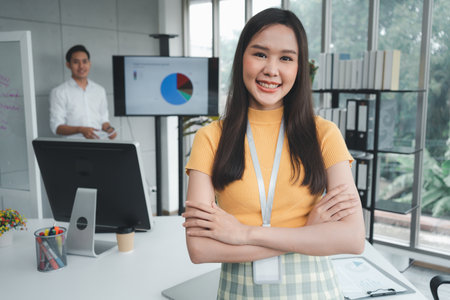 Young Asian Happy Businesswoman or intern in Modern Office background is Colleagues discuss with new startup project Idea. Empowered Digital Entrepreneur Works on Startup Projectの写真素材