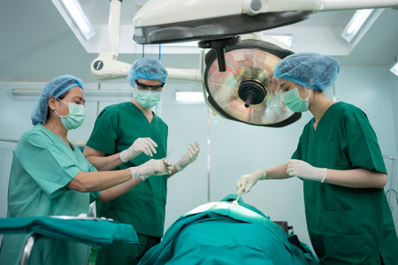 Asian Professional surgeons team performing surgery in the operating room, surgeon, Assistants, and Nurses Performing Surgery on a Patient, health care cancer and disease treatment conceptの写真素材