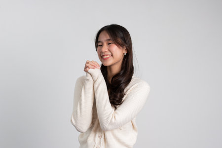 Happy cheerful young Asian girl with long light hair smiling brightly feeling happy with a positive expression, joyful surprise funky, Female in black with a big smile isolated on white background.の写真素材
