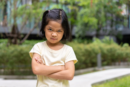 Portrait of an Asian angry and sad little girl. The emotion of a child when tantrum and mad, expression of grumpy emotion. Kid emotional control, attention deficit hyperactivity disorder concept ADHDの写真素材