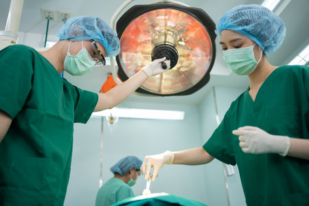 Asian Professional surgeons team performing surgery in the operating room, surgeon, Assistants, and Nurses Performing Surgery on a Patient, health care cancer and disease treatment conceptの写真素材