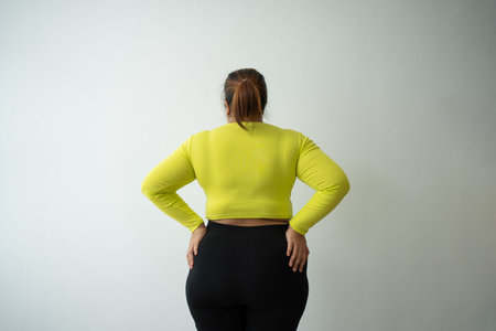 Overweight woman using a tape measure around waist and belly fat, Fat Asian woman workout at home....