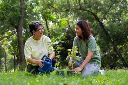 Old Asian Women and daughter join as volunteers for reforestation, earth conservation activities for reduce global warming growth feature and take care nature earth. Environment Conceptの写真素材
