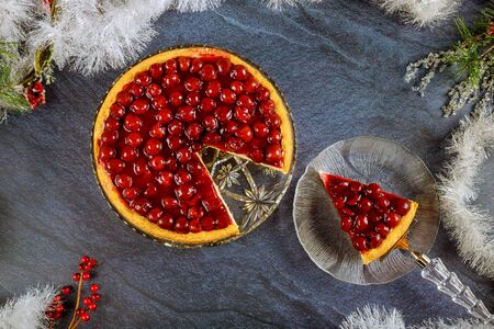 Cheesecake with cherry topping and christmas decoration. Top view.の写真素材