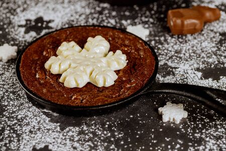 Christmas brownie decorated with snowflake candy with powdered sugar. Christmas and New Year concept.の写真素材